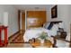 Relaxing bedroom featuring hardwood floors, an area rug, wood trim, and a large closet at 1050 N Corona St # 312, Denver, CO 80218