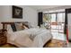 Bright bedroom with hardwood floors and sliding doors leading to a deck at 1050 N Corona St # 312, Denver, CO 80218