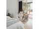 Bedroom with hardwood floors and sliding doors leading to a deck at 1050 N Corona St # 312, Denver, CO 80218