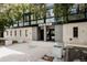 Modern building exterior with a clean design, featuring trees, plants, and concrete pavers at 1050 N Corona St # 312, Denver, CO 80218
