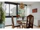 Bright dining area with wooden table set and woven pendant lighting fixture at 1050 N Corona St # 312, Denver, CO 80218