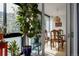 Bright dining area with wooden table set and woven pendant lighting fixture next to sunroom at 1050 N Corona St # 312, Denver, CO 80218