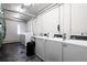 Clean, brightly-lit laundry room with several washing machines at 1050 N Corona St # 312, Denver, CO 80218