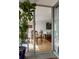 Open concept living area with dining table and living room with access to sunroom at 1050 N Corona St # 312, Denver, CO 80218