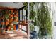 Bright sunroom with lots of natural light, shelves, and plants at 1050 N Corona St # 312, Denver, CO 80218
