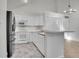 Well-equipped kitchen featuring white cabinets and breakfast bar at 11127 Alcott St # A, Denver, CO 80234