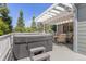 Backyard deck with a hot tub, outdoor seating, and views of the lush greenery at 6258 Lancaster Ave, Castle Rock, CO 80104