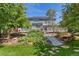 Spacious backyard featuring a two-story home, deck, lush landscaping, and a stone walkway at 6258 Lancaster Ave, Castle Rock, CO 80104