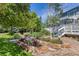 Backyard garden with raised flower beds, a wooden walkway, and verdant landscaping at 6258 Lancaster Ave, Castle Rock, CO 80104