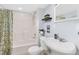 Bathroom with a white sink, toilet, and shower-tub combo at 6258 Lancaster Ave, Castle Rock, CO 80104