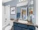 Bathroom featuring blue cabinets and granite countertop at 6258 Lancaster Ave, Castle Rock, CO 80104