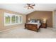 Primary bedroom featuring a ceiling fan, shuttered windows, and carpeted floors at 6258 Lancaster Ave, Castle Rock, CO 80104