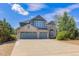 Charming two-story home featuring a stone facade, three-car garage, well-maintained landscaping, and a spacious driveway at 6258 Lancaster Ave, Castle Rock, CO 80104