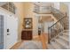 Elegant foyer with hardwood floors, staircase, chandelier, and a view of the upper level, creating a grand entrance at 6258 Lancaster Ave, Castle Rock, CO 80104