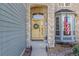 Charming front entrance with stone archway, decorative wreath, bay window, and American flag, creating a welcoming curb appeal at 6258 Lancaster Ave, Castle Rock, CO 80104