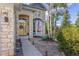 Inviting front entrance features stone accents, a decorative door, and mature trees, creating a welcoming ambiance at 6258 Lancaster Ave, Castle Rock, CO 80104