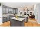 Open concept kitchen flows into living room featuring stainless appliances, granite countertops, and a kitchen island at 6258 Lancaster Ave, Castle Rock, CO 80104