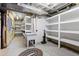 Unfinished basement area with utility sink and open shelving at 5604 Singletree Ln, Parker, CO 80134