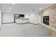 Finished basement showcasing a stone fireplace, bar area, and neutral carpeting at 5604 Singletree Ln, Parker, CO 80134