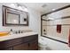 Modern bathroom with a granite countertop and a shower with glass door enclosure at 5604 Singletree Ln, Parker, CO 80134