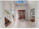 Spacious foyer with a soaring ceiling and elegant tile flooring creates a grand entrance at 5604 Singletree Ln, Parker, CO 80134