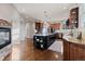 Spacious kitchen with hardwood floors, stone fireplace, large island, and updated appliances at 5604 Singletree Ln, Parker, CO 80134