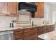 Kitchen details include granite countertops, tile backsplash, wood cabinets, and a modern vent hood at 5604 Singletree Ln, Parker, CO 80134