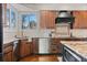Close-up of kitchen features granite counters, stainless steel appliances, and wood cabinetry at 5604 Singletree Ln, Parker, CO 80134