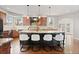 Beautiful kitchen island with barstool seating, granite countertop, updated fixtures, and stainless appliances at 5604 Singletree Ln, Parker, CO 80134