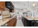 Gourmet kitchen with oversized island, granite counters, stainless appliances, and sleek cabinetry at 5604 Singletree Ln, Parker, CO 80134