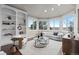 Bright living room with built-in shelving and expansive windows offers scenic views at 5604 Singletree Ln, Parker, CO 80134
