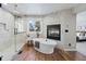 This luxurious bathroom offers a soaking tub, walk-in shower, and a cozy fireplace at 5604 Singletree Ln, Parker, CO 80134