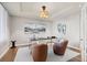 Cozy office space features hardwood floors, a modern light fixture, and ample natural light at 5604 Singletree Ln, Parker, CO 80134