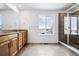 Modern bathroom with double sink vanity, tile floors, and glass shower enclosure at 16634 W 93Rd Way, Arvada, CO 80007