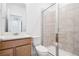 Modern bathroom with tiled shower, glass door, and stylish vanity with mirror and sink at 16634 W 93Rd Way, Arvada, CO 80007