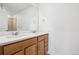Bathroom with double sink vanity, wood cabinets and quartz countertop at 16634 W 93Rd Way, Arvada, CO 80007
