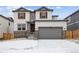 Charming two-story home featuring stone accents, attached two-car garage, and manicured front yard at 16634 W 93Rd Way, Arvada, CO 80007