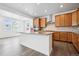 Open kitchen with stainless steel appliances, center island, and a large window overlooking the backyard at 16634 W 93Rd Way, Arvada, CO 80007