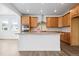 Modern kitchen features stainless steel appliances, wood cabinets, and an oversized kitchen island at 16634 W 93Rd Way, Arvada, CO 80007