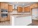 Beautiful kitchen featuring stainless steel appliances, wood cabinets, and an oversized kitchen island at 16634 W 93Rd Way, Arvada, CO 80007