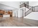 Spacious open-concept living room featuring hardwood floors and a staircase with wood and metal railings at 16634 W 93Rd Way, Arvada, CO 80007
