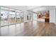 Open-concept living area with hardwood floors and large sliding glass doors leading to deck at 16634 W 93Rd Way, Arvada, CO 80007