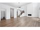 Bright and spacious living room featuring wood floors and a staircase with wood and metal railings at 16634 W 93Rd Way, Arvada, CO 80007