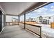 Covered patio with wood railings overlooking a snowy backyard and neighborhood at 16634 W 93Rd Way, Arvada, CO 80007