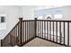Staircase with carpeted steps and wood railing at 16634 W 93Rd Way, Arvada, CO 80007