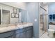 Bright bathroom with dual sinks, granite counters, and walk-in shower at 7995 E Mississippi Ave # C11, Denver, CO 80247