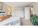 Bedroom features a large wardrobe with a plant near the door at 7995 E Mississippi Ave # C11, Denver, CO 80247