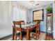 Cozy dining room with hardwood floors, large window, and a view to the kitchen at 7995 E Mississippi Ave # C11, Denver, CO 80247