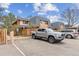 Townhome complex with mature trees, ample parking, and visible accessibility parking space at 7995 E Mississippi Ave # C11, Denver, CO 80247
