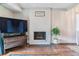 Bright living room featuring a classic painted brick fireplace and a flatscreen TV at 7995 E Mississippi Ave # C11, Denver, CO 80247